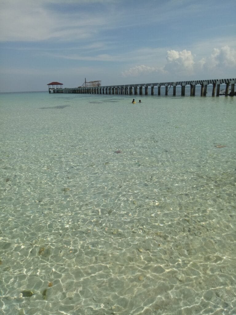 Shallow and crystal clear water of Malamawi Beach